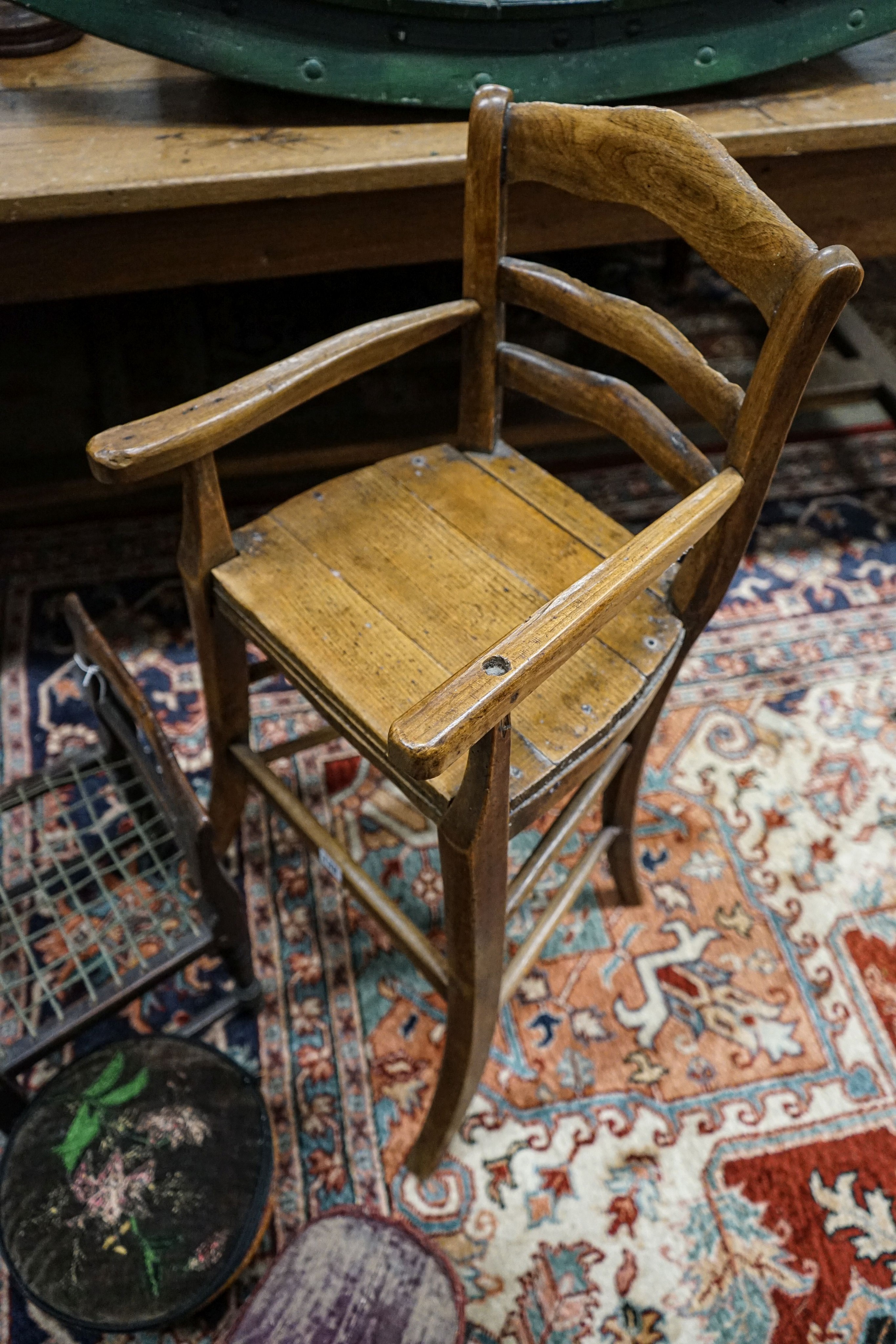 An early 19th century primitive mahogany child's chair, with strung seat, height 29cm, a beech high chair, height 85cm and two small child's stools
